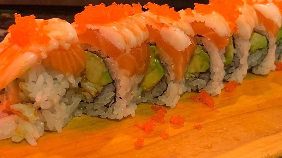 The Orange River roll topped with salmon, shrimp and masago at Sushi Ai