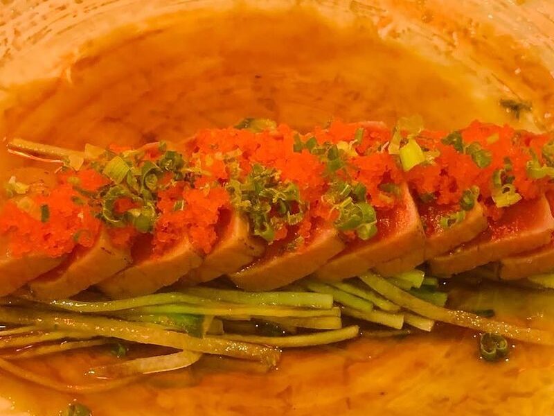 Seared tuna tataki topped with masago and scallions in ponzu