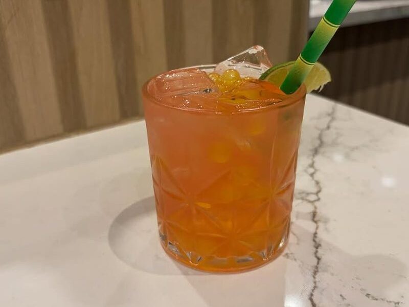 A strawberry margarita topped with mango boba and lime at Sushi Ai